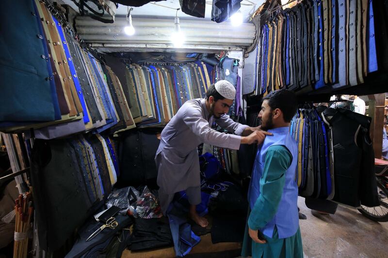 A Pakistani tries traditional coat ahead of Eid al-Fitr in Peshawar, Pakistan.  EPA