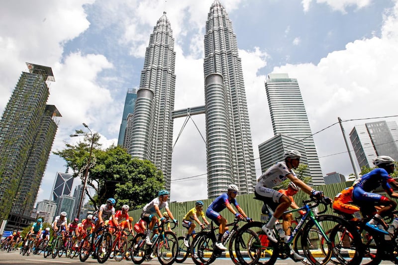 Cyclists move past Malaysia's landmark Petronas Twin Towers during the last stage of Le Tour de Langkawi cycling race in Kuala Lumpur, Malaysia, Sunday, March 25, 2018. The 23rd edition of Le Tour de Langkawi cover more than 1,200 kilometers over 8 stages and classed as a 2HC race in the Asia Tour Circuit. (AP Photo/Sadiq Asyraf)
