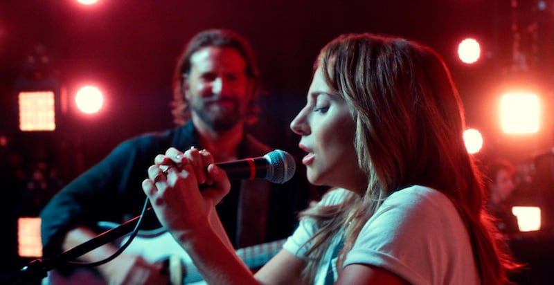 This image released by Warner Bros. shows Bradley Cooper, left, and Lady Gaga in a scene from the latest reboot of the film, "A Star is Born." Surely literal goosebumps are a good sign that youâ€™ve just seen a pretty stunning movie moment, specifically where Lady Gagaâ€™s Ally takes a deep breath and walks out on stage to join Bradley Cooperâ€™s Jackson Maine and sing her song in front of thousands of people. (Neal Preston/Warner Bros. via AP)