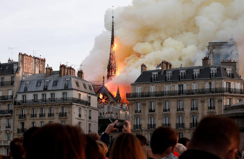 Smoke billows as fire engulfs the spire of Notre Dame Cathedral in Paris, France, April 15, 2019. Picture taken April 15, 2019. REUTERS/Benoit Tessier/File Photo  SEARCH "POY DECADE" FOR THIS STORY. SEARCH "REUTERS POY" FOR ALL BEST OF 2019 PACKAGES. TPX IMAGES OF THE DAY.