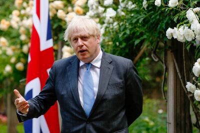 epa09272673 British Prime Minister Boris Johnson, gestures during a joint news conference with Australian counterpart Scott Morrison, during their bilateral meeting in the garden of number 10 Downing Street in London, Britain, 15 June 2021. The U.K. is set to announce the broad terms of a free-trade deal with Australia on 15 June, its latest post-Brexit accord as Prime Minister Boris Johnson seeks to expand commerce beyond the European Union.  EPA/Luke MacGregor / POOL