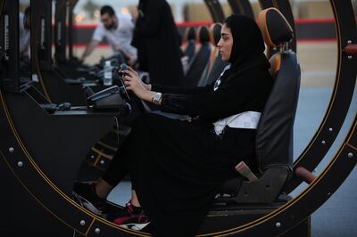 JEDDAH, SAUDI ARABIA - JUNE 23:  A young woman wearing an abaya tries out a driving simulator at an outdoor educational driving event for women on June 23, 2018 in Jeddah, Saudi Arabia. Saudi Arabia is scheduled to lift its ban on women driving, which has been in place since 1957, on June 24. The Saudi government, under Crown Prince Mohammad Bin Salman, is phasing in an ongoing series of reforms to both diversify the Saudi economy and to liberalize its society. The reforms also seek to empower women by restoring them basic legal rights, allowing them increasing independence and encouraging their participation in the workforce. Saudi Arabia is among the most conservative countries in the world and women have traditionally had much fewer rights than men.  (Photo by Sean Gallup/Getty Images)