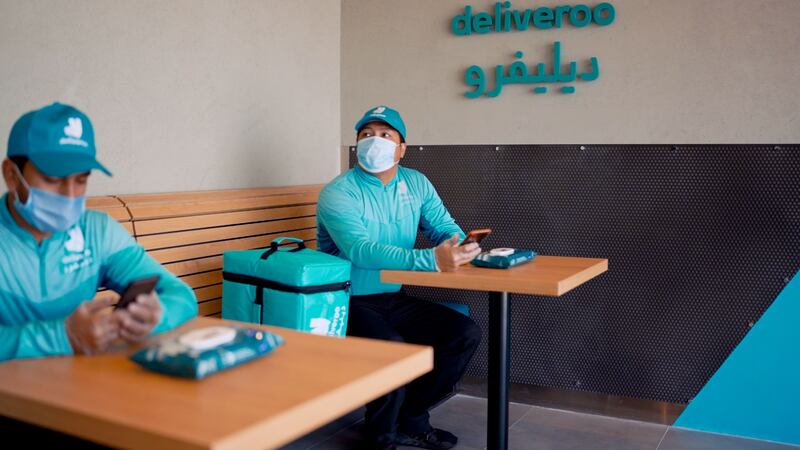 Staff at Deliveroo's new Hessa Street dark kitchen site wait to colllect a delivery. Courtesy: Deliveroo