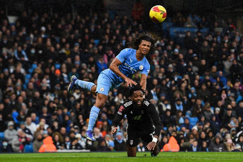 Manchester City's defender Nathan Ake, left, fights for the ball with Fulham's striker Ivan Cavaleiro. AFP