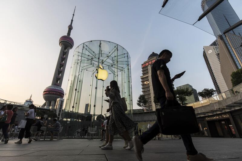 Pedestrians walk past an Apple Inc. store in Shanghai, China, on Monday, July 29, 2019. Chinese trade negotiators will host their U.S. counterparts at a landmark of jazz-era Shanghai on the city's riverside Bund, re-opening trade talks with a marked change of atmosphere after an almost three-month hiatus. Photographer: Qilai Shen/Bloomberg