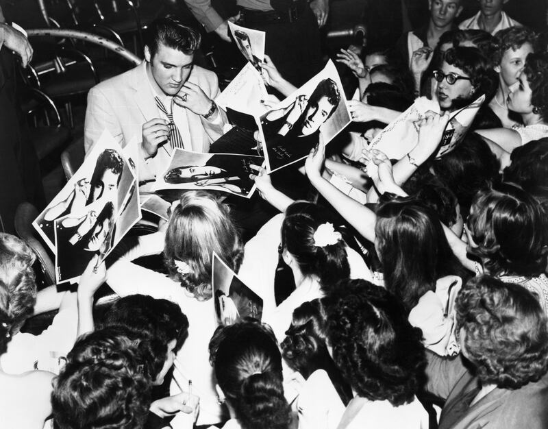 Elvis surrounded by his adoring teenage fans in 1956