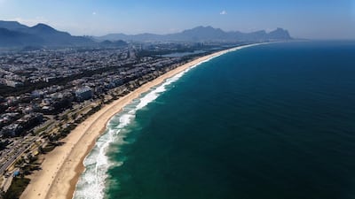 epa08596378 An aerial image made with a drone of Recreio beach, in Rio de Janeiro, Brazil, 10 August 2020. In Rio de Janeiro, the most emblematic city in Brazil, Cariocas and tourists who wish to sunbathe on the beaches will have to reserve their space through a mobile application, Mayor Marcelo Crivella announced on 10 August. According to the Mayor, details on how the reservation system will work will be announced towards the weekend and in the meantime he asked people not to crowd on the beaches.  EPA/Antonio Lacerda