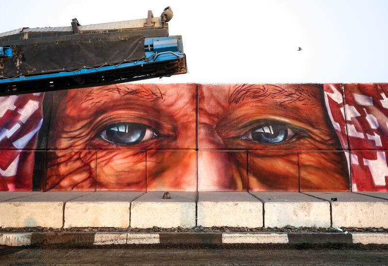 Eyes at street level gaze out at passersby.