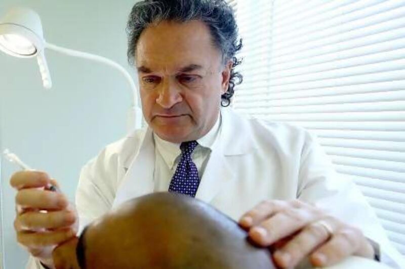 Dr George Lefkovits performs cosmetic surgery at the BodywoRx Aesthetic Clinic. Satish Kumar / The National
