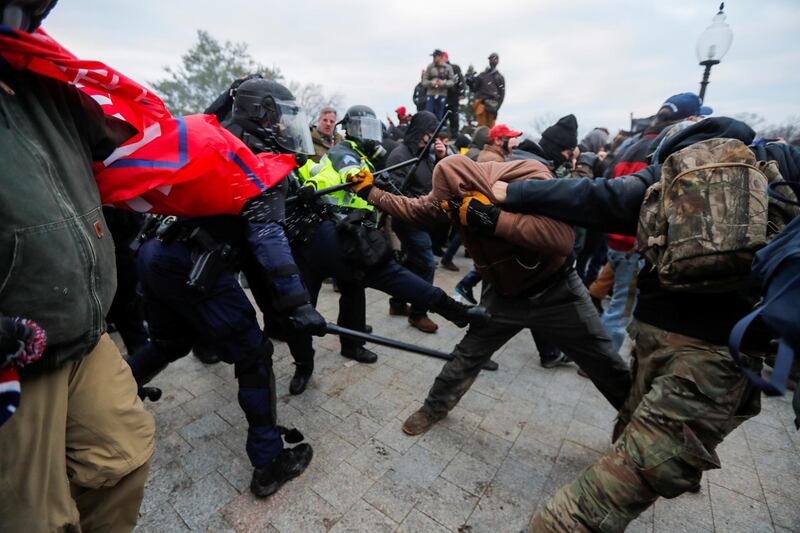 Law enforcement officers scuffle supporters of U.S. President Donald Trump attempting to enter U.S. Capitol during a protest against the certification of the 2020 U.S. presidential election results by the U.S. Congress, in Washington, U.S., January 6, 2021. REUTERS/Jim Bourg