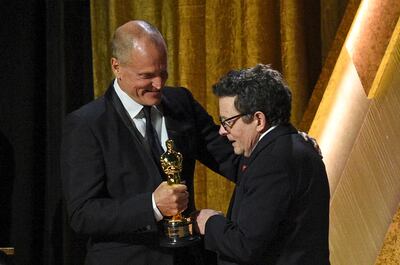 Michael J Fox, right, accepts the Jean Hersholt Humanitarian Award from long-time friend and actor Woody Harrelson. AP