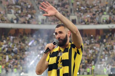 French forward Karim Benzema greets the crowd during his unveiling as an Al Ittihad player at King Abdullah Sports City stadium in Jeddah, on June 8, 2023. AFP
