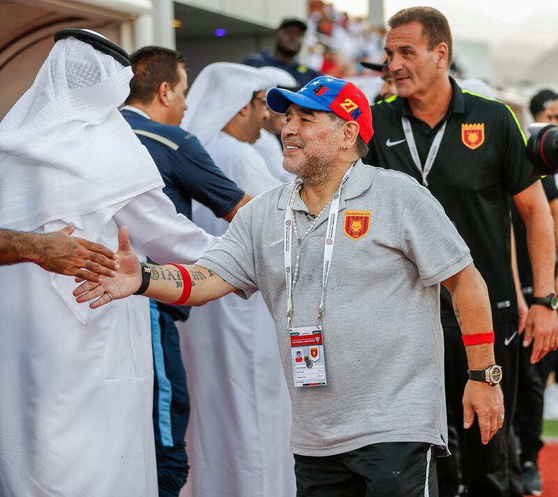 Fujairah, UAE, April 27, 2018.  Final round of 2017/18 First Division. Diego Maradona and Fujairah set to seal promotion to the Arabian Gulf League.   Football legend Diego Maradona shakes hands with the coaches of Khorfakkanteam before the match.
Victor Besa / The National
Sports
Reporter: John McAuley.