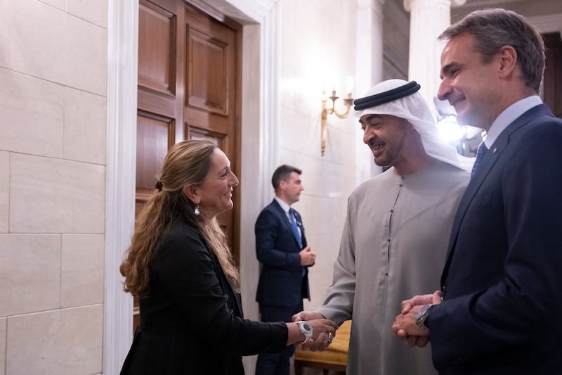 President Sheikh Mohamed greets a member of the Greek delegation during a reception hosted by Mr Mitsotakis.