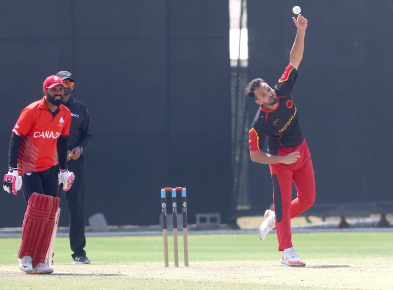 Germany's Muslim Yar bowls during the T20 World Cup Qualifier play-off match between Canada and Germany in Muscat, Oman, on February 22, 2022. Subas Humagain for The National