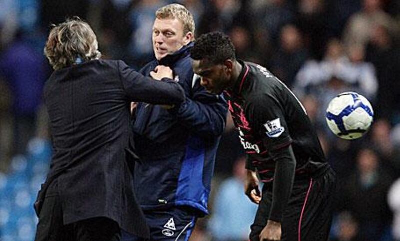 David Moyes, centre, was involved in a touchline fracas with Roberto Mancini, the Manchester City manager, left, during Everton's 2-0 win at Eastlands on Wednesday.