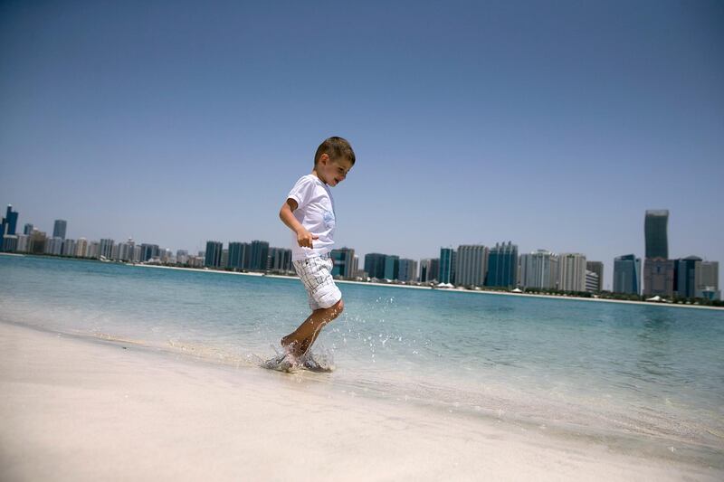 Abu Dhabi, UNITED ARAB EMIRATES, June 5, 2014:  
A boy, a young tourist, runs through the water at the Breakwater Corniche in Abu Dhabi, on Thursday, June 5, 2014.
(Silvia Razgova / The National)

Reporter: standalone
Section: National
Usage: June 5, 2014
