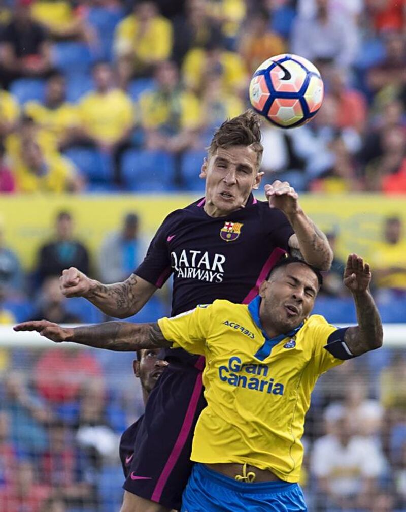Barcelona’s French defender Lucas Digne, top, vies with Las Palmas forward Jonathan Viera. Jaime Reina / AFP