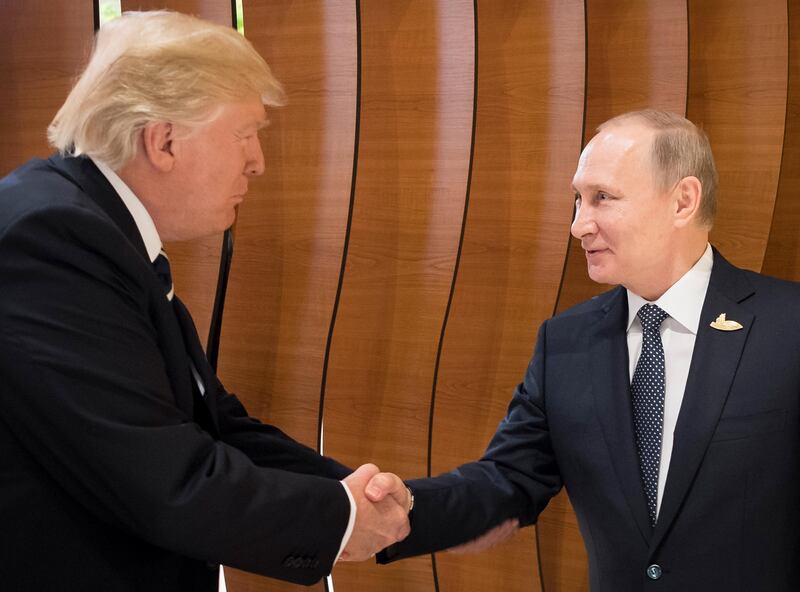 Mr Trump greets Russian president Vladimir Putin Steffen Kugler / EPA