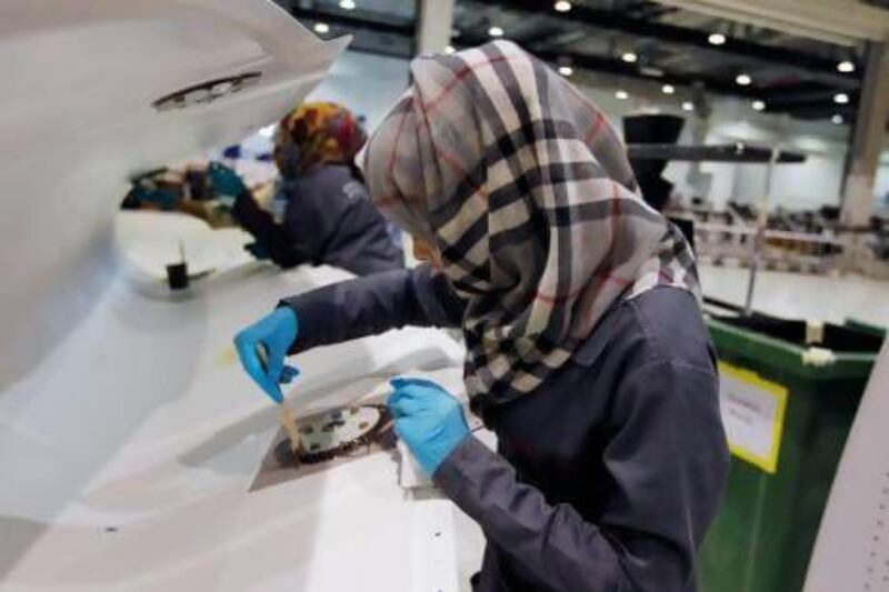 A technician applies final touches to a flap track fairing at Strata in Al Ain. Reuters