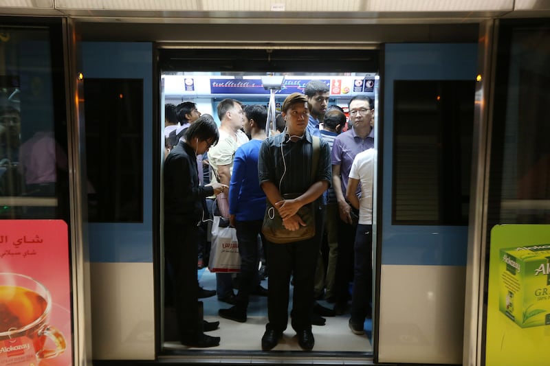 DUBAI , UNITED ARAB EMIRATES Ð Sep 2 , 2014 : People traveling in Dubai Metro in Dubai. ( Pawan Singh / The National ) For News. Story by Preeti & Martin