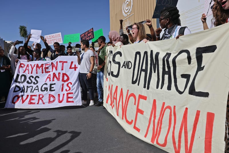 Banners and shouting demonstrators outside the conference centre. AFP