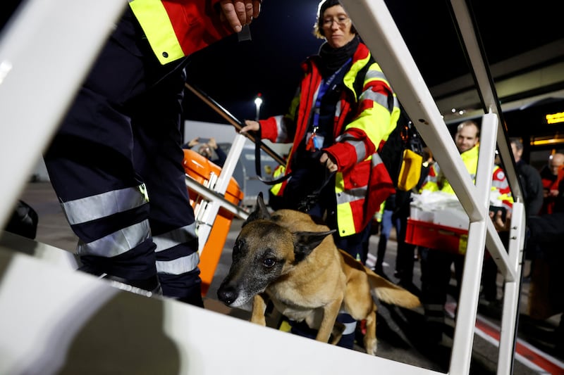 Members of International Search and Rescue Germany board a charter plane with a search dog at Cologne-Bonn airport, Germany. Reuters