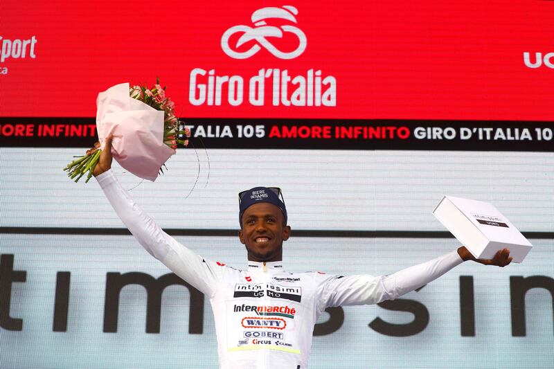 Team Wanty rider Biniam Girmay Hailu celebrates his best young rider white jersey on the podium after the first stage of the Giro d'Italia. AFP