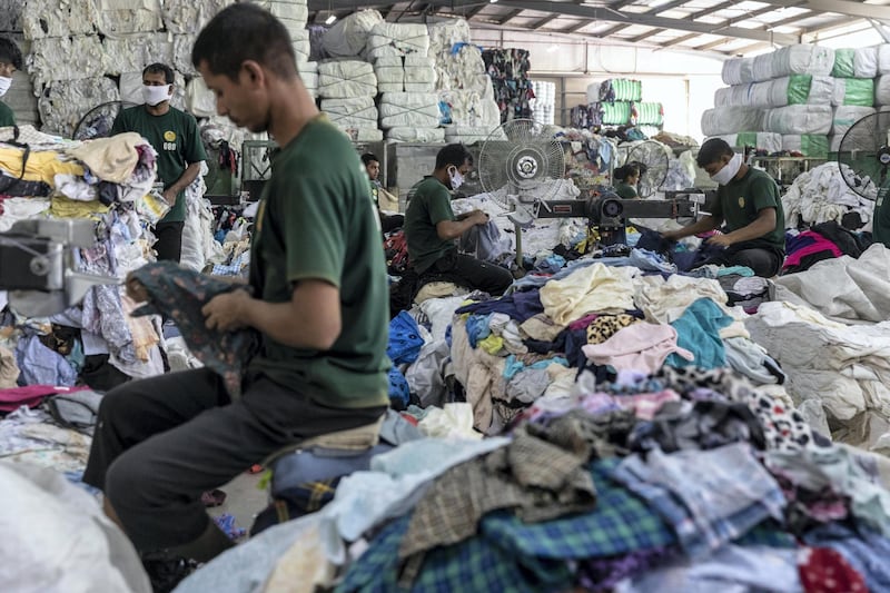 DUBAI, UNITED ARAB EMIRATES. 24 OCTOBER 2019. Second hand clothing from the UK, Australia and Europe is sported by type and quality at Hands Industries in Sharjah. Some clothes are destined to be re sold in third world markets in Africa while other damaged items are cut for use as rags in Industrial or commercial applications. (Photo: Antonie Robertson/The National) Journalist: Kelly Clarke. Section: National.
