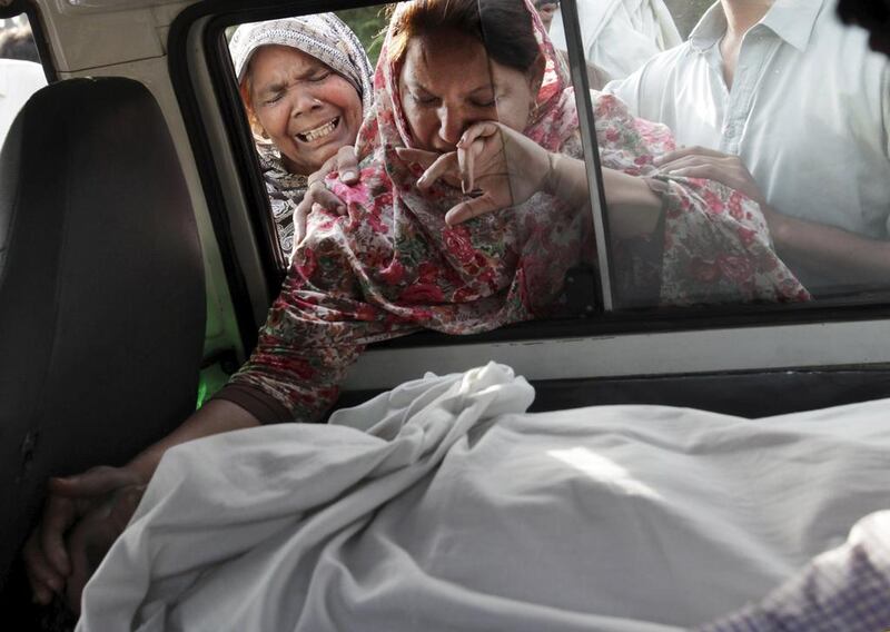 The sister of Aftab Bahadur touches her brother's face after his body was placed in a van to be taken for burial following his execution at Kot Lakhpat jail in Lahore, Pakistan. Mohsin Raza/Reuters