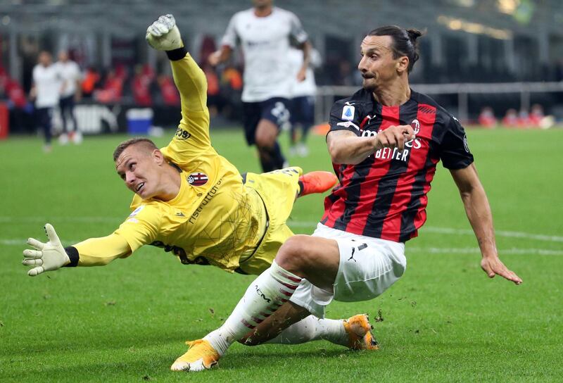 Zlatan Ibrahimovic challenges for the ball against Bologna goalkeeper Lukas Skorupski. EPA