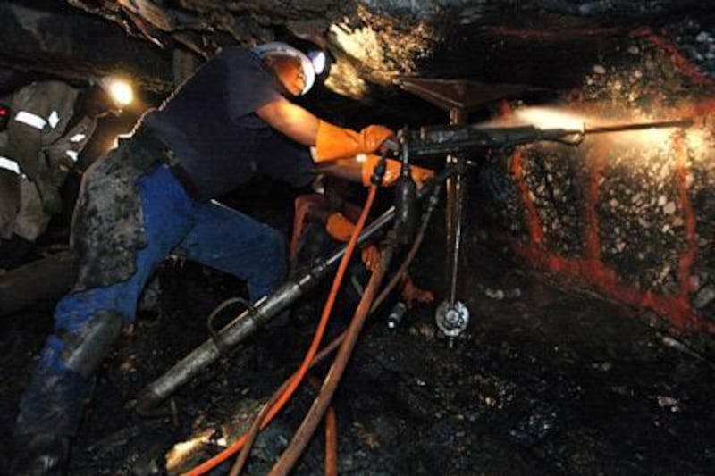 Mines drill underground at Anglo Gold Ashanti's Mponeng gold mine near Carltonville, South Africa, Thursday, May 25, 2006. Photographer: Naashon Zalk / Bloomberg News