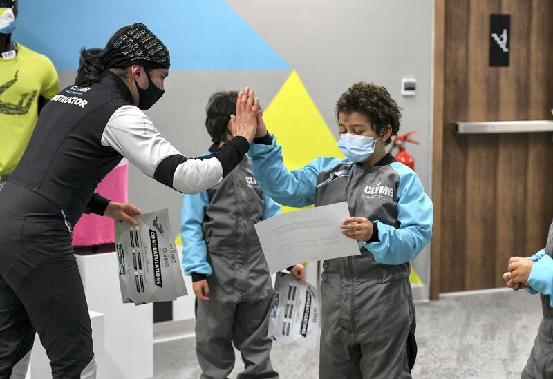 Abu Dhabi, United Arab Emirates - Mazen, 7, and Samih, 9, receive Certificates from the instructor after their indoor skydiving adventure at CLYMB, Yas Island. Khushnum Bhandari for The National