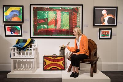 LONDON, ENGLAND - OCTOBER 20:  A woman arranges items from the personal collection of Howard Hodgkin during a press call for the India & Islamic Exhibition at Sotheby's on October 20, 2017 in London, England.  Sotheby's opens its public exhibition of Arts of the Middle East & India featuring the personal collection of the late British artist Howard Hodgkin, ahead of next week's auctions in London. The personal collection of the late British artist Howard Hodgkin on view for the first time at Sotheby's London alongside the exhibition of Arts of the Middle East and India.  (Photo by Chris J Ratcliffe/Getty Images for Sotheby's)