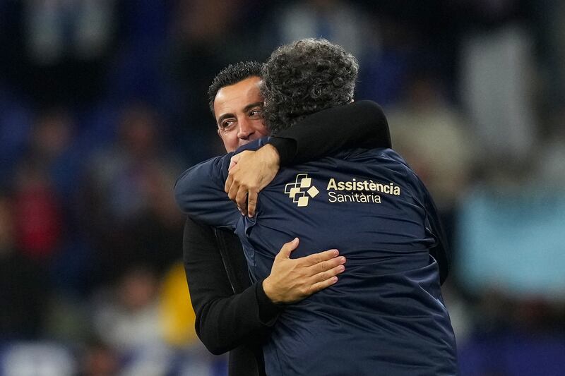 Barcelona coach Xavi celebrates with a member of his backroom staff after the 4-2 win over Espanyol at RCDE Stadium clinched La Liga. AFP
