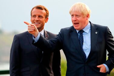 British Prime Minister Boris Johnson (right) gestures past French President Emmanuel Macron at the Biarritz lighthouse, southwestern France, ahead of a working dinner on the first day of the annual G7 Summit. AFP