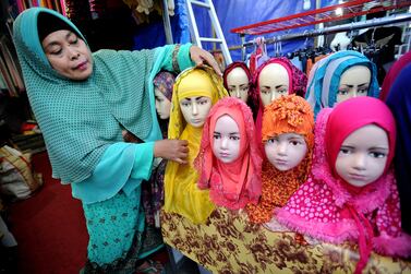 A vendor prepares hijabs for sale during Ramadan in Surabaya, Indonesia. The particular type of feminism followed by Muslim women can make immense contributions to gender equality, says Shelina Janmohamed (Photo by Robertus Pudyanto/Getty Images)