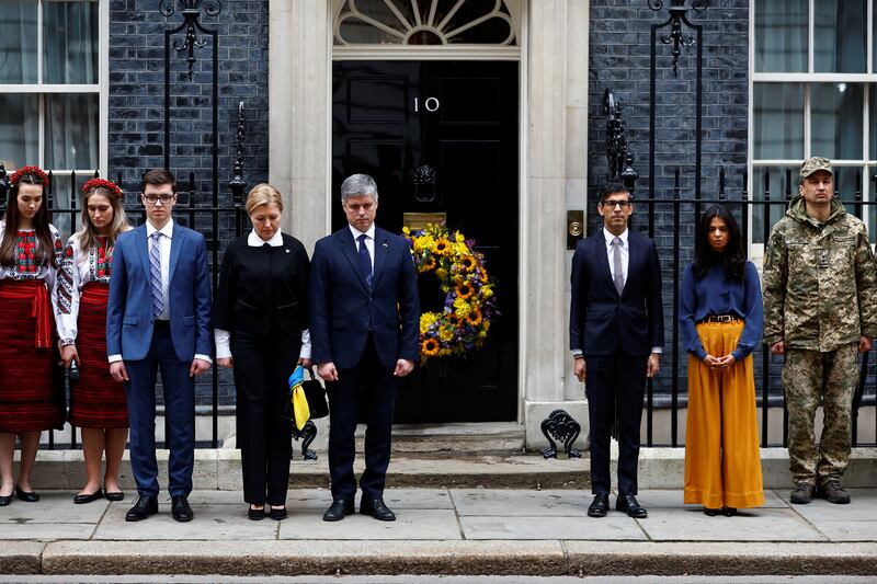 British Prime Minister Rishi Sunak and his wife Akshata Murthy, with Ukrainian ambassador to the UK Vadym Prystaiko and wife Inna Prystaiko, observe a minute's silence at 10 Downing Street. Reuters