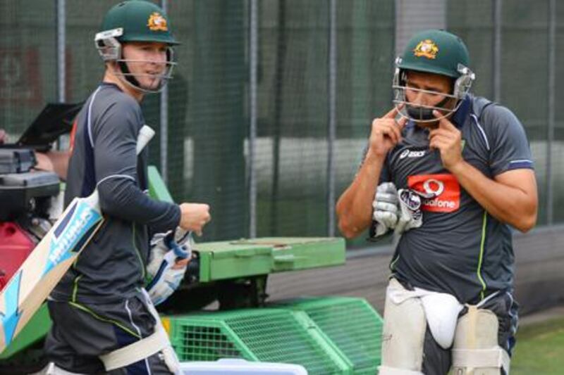 Australia captain Michael Clarke heads for training with Usman Khawaja - the batsman who will replace him if he fails to recover from injury.