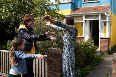 Rend Platings, right, and her daughter Samantha welcome Kristina Korniiuk to their home in Cambridge. PA