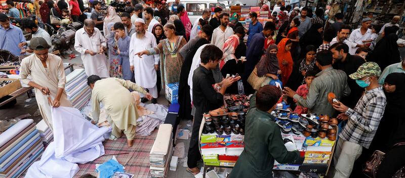 People shop from stalls ahead of Eid in Karachi, Pakistan. REUTERS