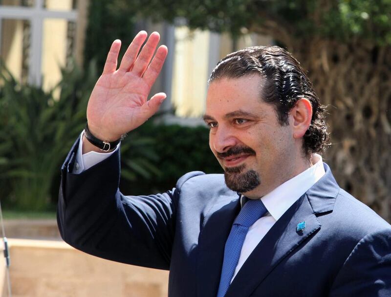 Former Lebanese prime minister Saad Hariri waves upon his arrival at the government house in Beirut on Aug 8, 2014. Dalati Nohra / AP Photo