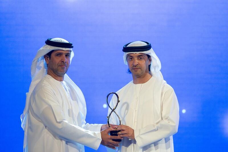 Sheikh Hazza bin Zayed, presenting an award to Masaood Ahmed Al Masaood, who received the award on behalf of his uncle, Abdulla Mohamed Al Masaood, who was honoured for his long-standing service to the Government in the field of foreign service and his tireless charitable efforts. Ryan Carter / Crown Prince Court — Abu Dhabi