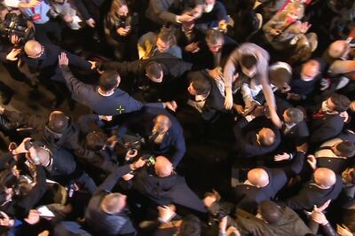 A man jumped from the crowd to grab Mr Zemmour by the neck during the chaotic rally near Paris. AFP 