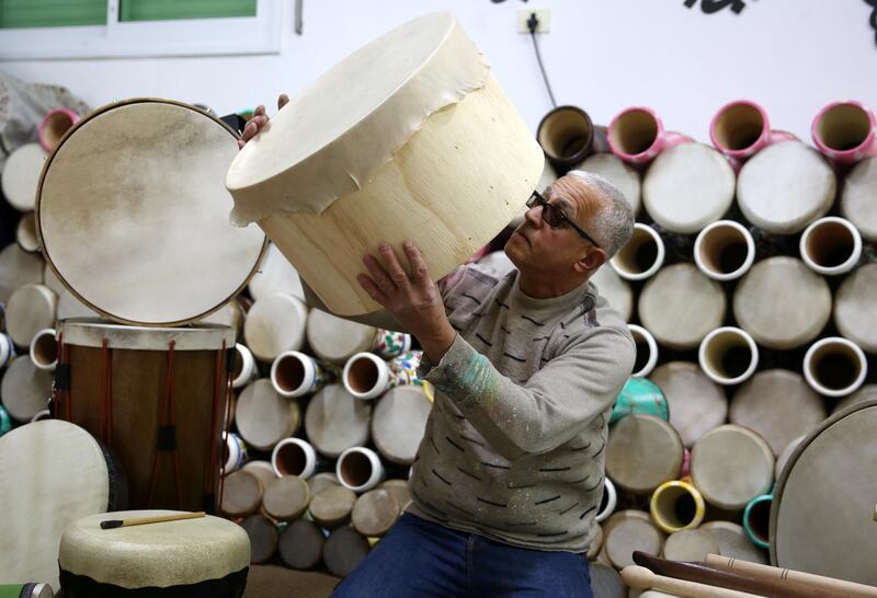 A Palestinian man makes drums in the Israeli occupied West Bank town of Hebron. Beating a drum to call on people to wake up for some last-minute eating before the start of the daily fast is a tradition followed in many parts of the world.  EPA