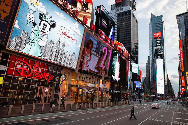 A police officer walks across an empty 7th Avenue in a sparsely populated Times Square due to COVID-19 concerns, in New York. AP Photo