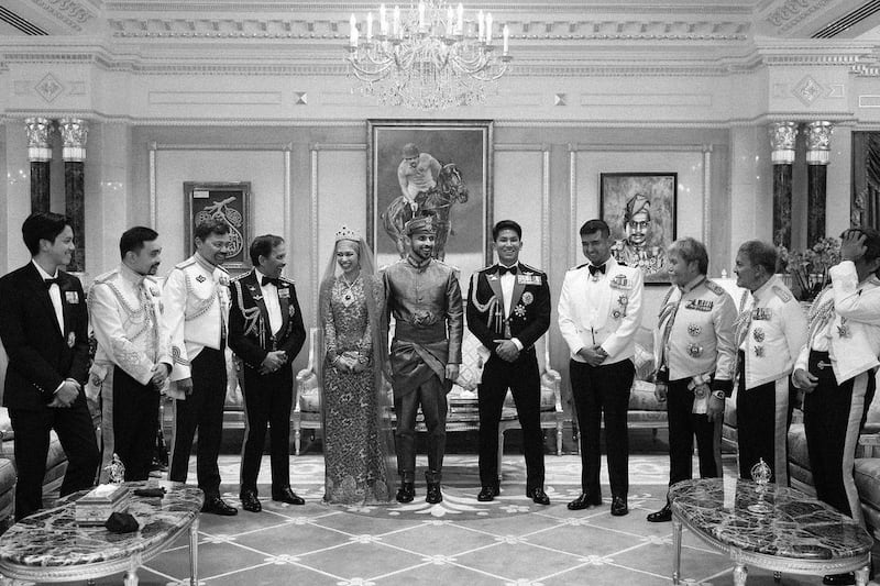 The couple, centre, with groomsmen at the wedding.