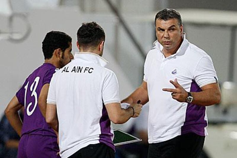 Al Ain have been transformed over pre-season by their new coach, Cosmin Olaroiu, right, who is looking to add a foreign striker to their ranks before the UAE football season starts.