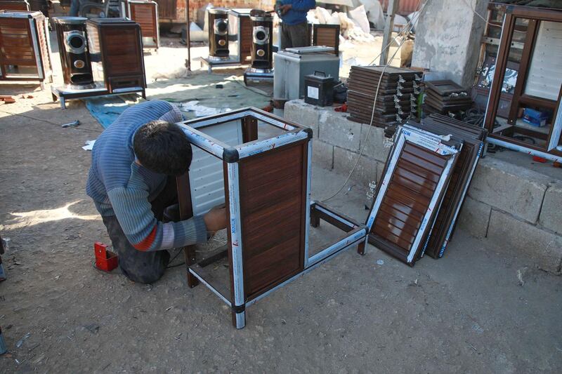 A Syrian man builds a pistachio-powered heater. AFP