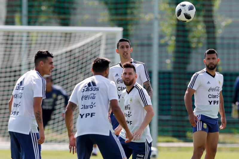Lionel Messi, centre, eyes the ball during training. Ricardo Mazalan / AP Photo